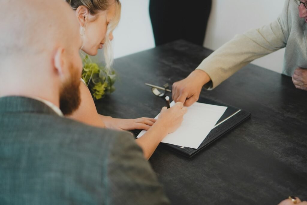 A couple signing loan documents at a law office